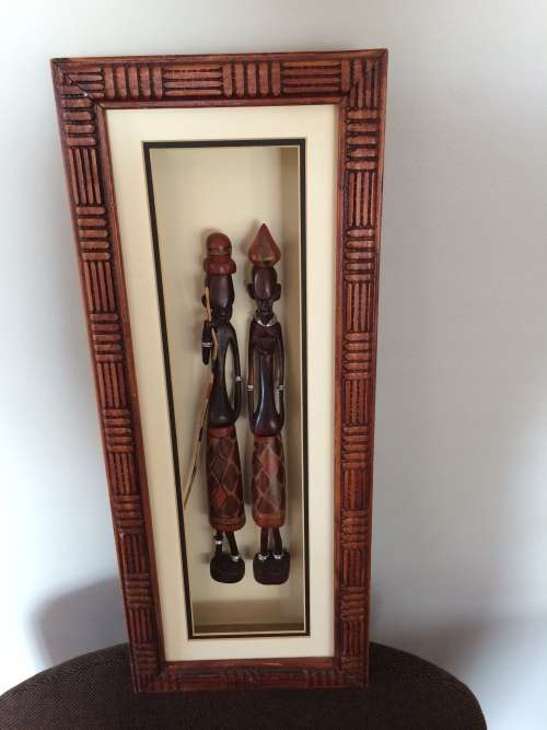 Tribal  carved figures in frame
